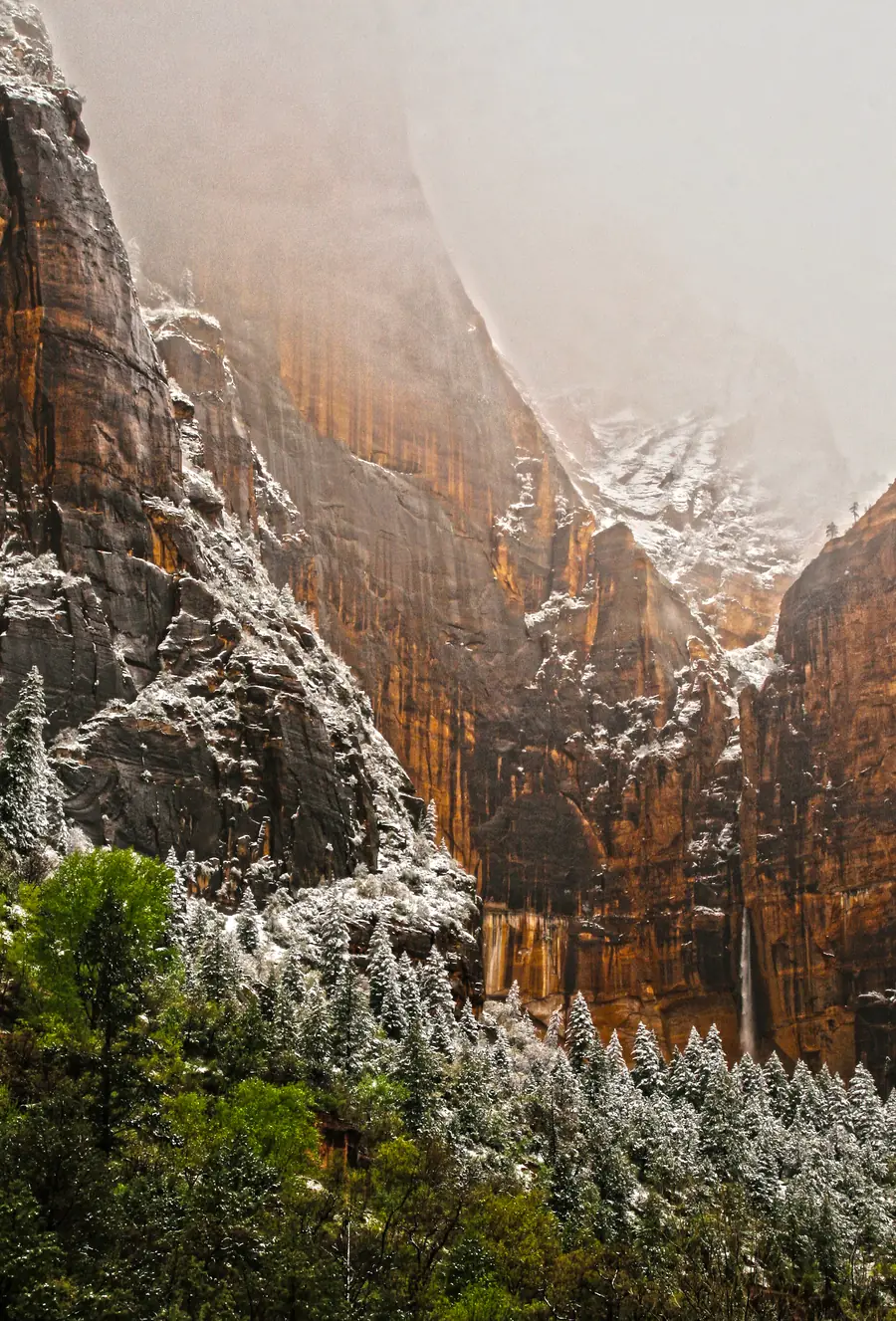 Water pouring down a tall cliff above the Upper Emerald Pool after spring rain and snow, Zion National Park.